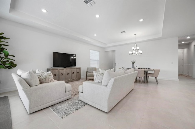 living area with light tile patterned floors, baseboards, visible vents, a tray ceiling, and recessed lighting