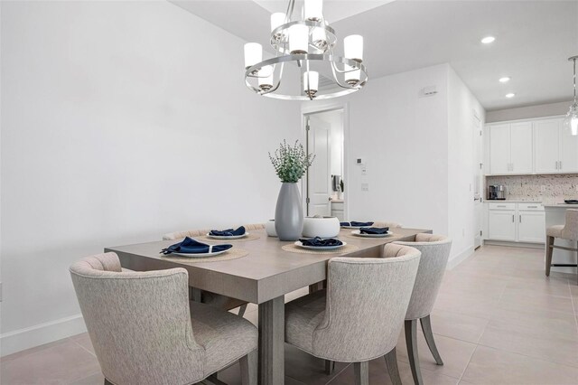 dining area with recessed lighting, baseboards, an inviting chandelier, and light tile patterned flooring