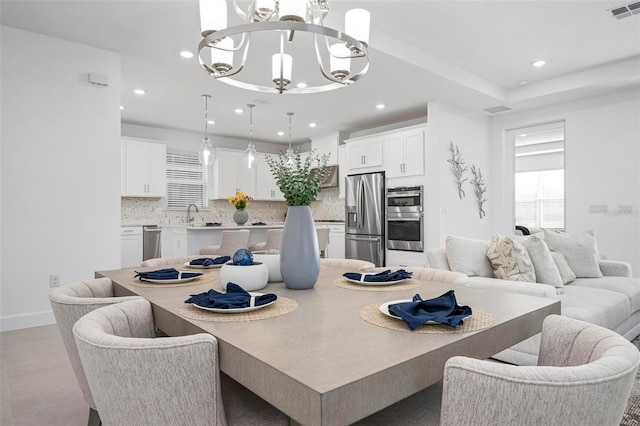 dining space featuring baseboards, recessed lighting, visible vents, and a chandelier