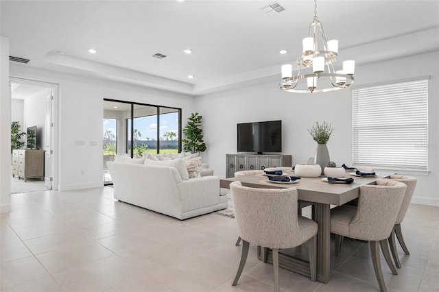 dining room with visible vents and a tray ceiling