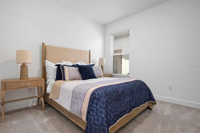 carpeted bedroom featuring baseboards