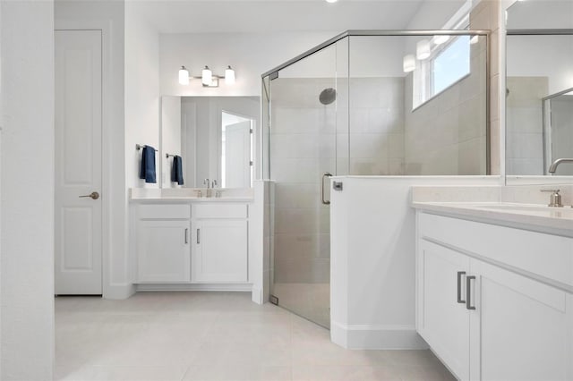 full bathroom with two vanities, a stall shower, and a sink