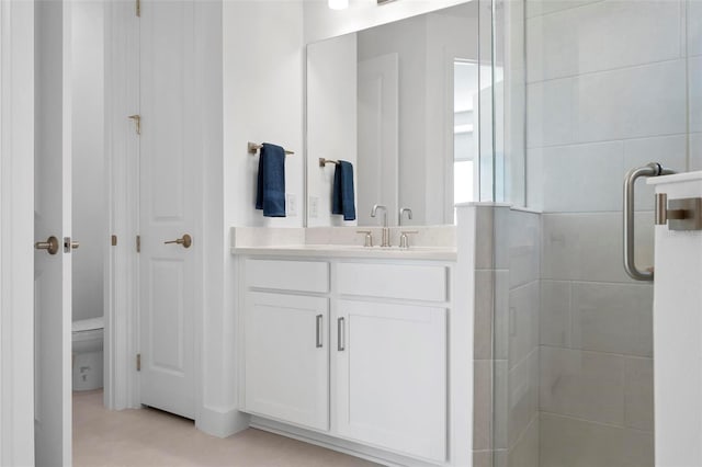 bathroom with a stall shower and vanity