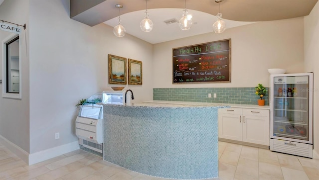 bar featuring wine cooler, tasteful backsplash, visible vents, and pendant lighting