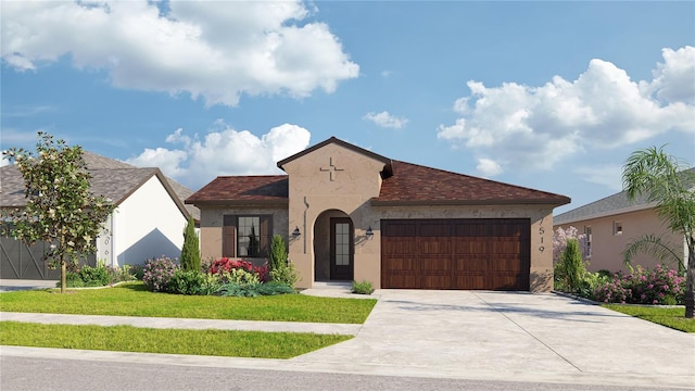 mediterranean / spanish-style house featuring an attached garage, concrete driveway, stucco siding, and a front yard