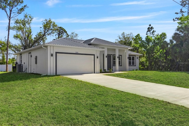 view of front of property with a front lawn, a standing seam roof, concrete driveway, an attached garage, and metal roof