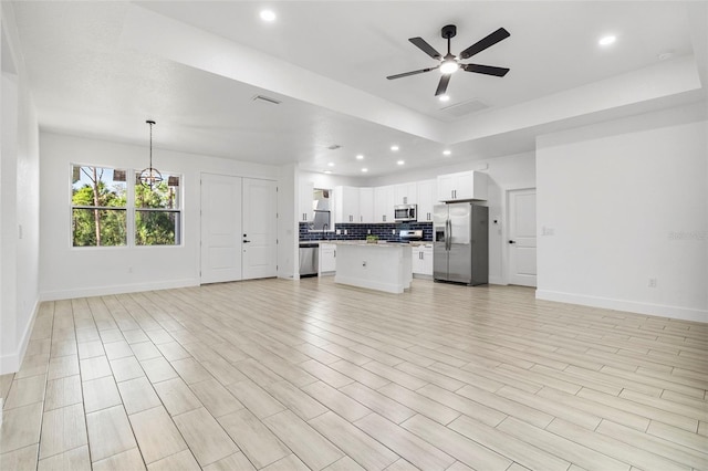 unfurnished living room featuring visible vents, baseboards, light wood-style flooring, recessed lighting, and ceiling fan