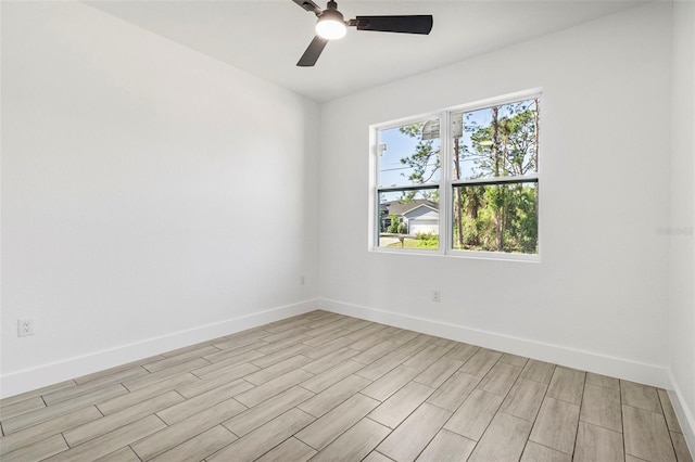 unfurnished room featuring light wood-style floors, baseboards, and ceiling fan