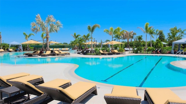 pool with a patio and fence