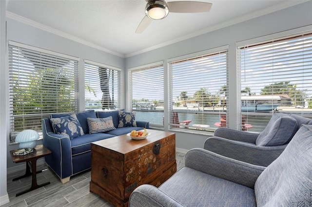 living room featuring ornamental molding, a wealth of natural light, and ceiling fan