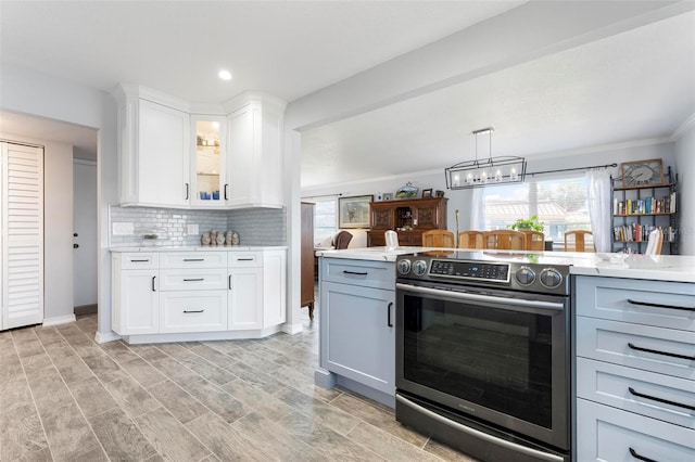 kitchen featuring backsplash, glass insert cabinets, light countertops, electric stove, and white cabinetry