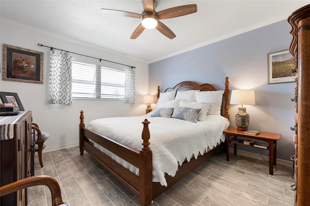 bedroom featuring crown molding, ceiling fan, baseboards, wood finish floors, and a textured ceiling