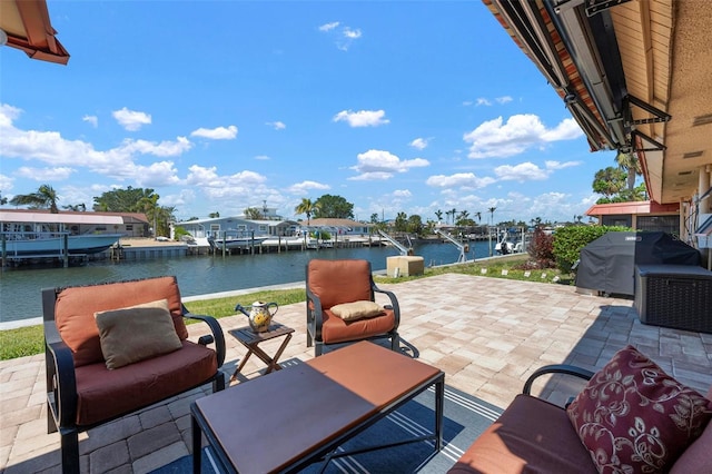 view of patio with area for grilling and a water view