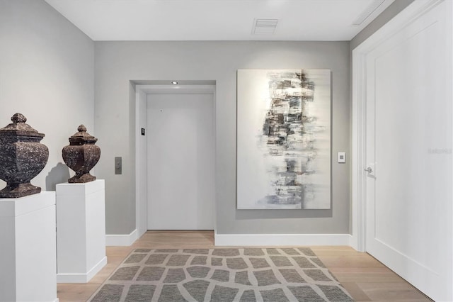 interior space featuring visible vents, baseboards, and light wood-style floors