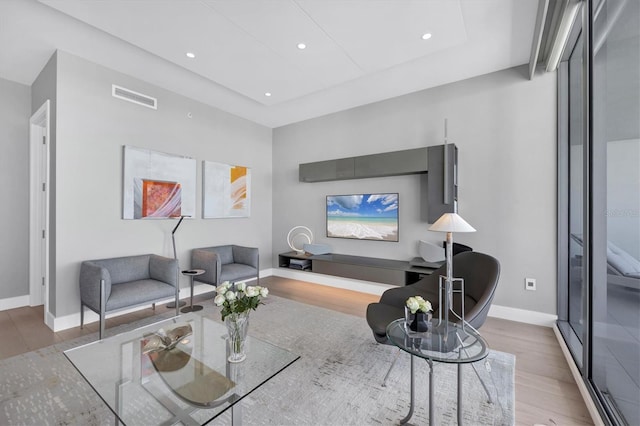 living room featuring visible vents, recessed lighting, baseboards, and wood finished floors