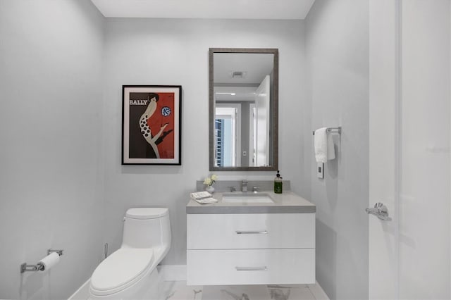 bathroom featuring visible vents, toilet, marble finish floor, baseboards, and vanity