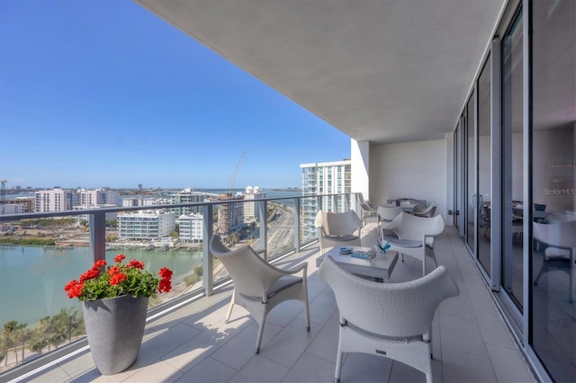 balcony featuring a view of city and a water view