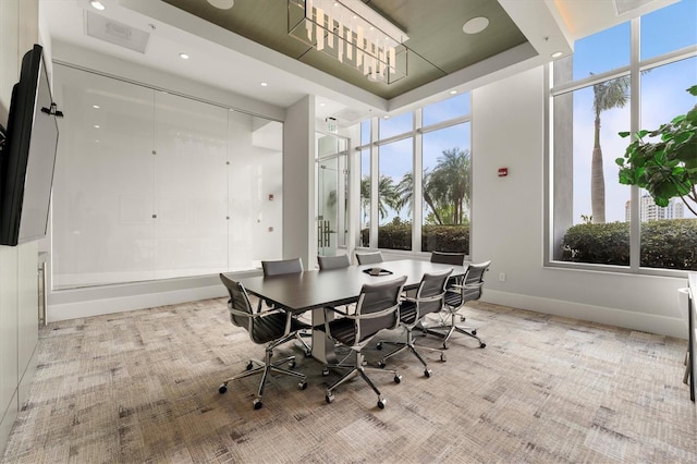 dining area with recessed lighting, a raised ceiling, and baseboards