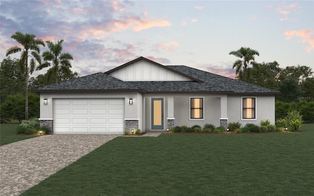 view of front of home featuring a front lawn, decorative driveway, an attached garage, and roof with shingles