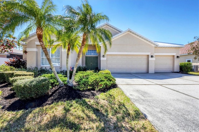 single story home featuring a garage, driveway, and stucco siding