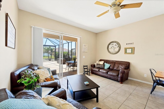 living room featuring light tile patterned floors, a ceiling fan, baseboards, and a sunroom