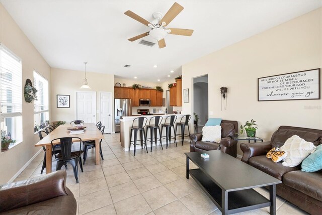 living area featuring visible vents, baseboards, ceiling fan, light tile patterned floors, and recessed lighting