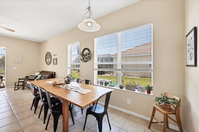 dining space with light tile patterned floors, ceiling fan, and baseboards