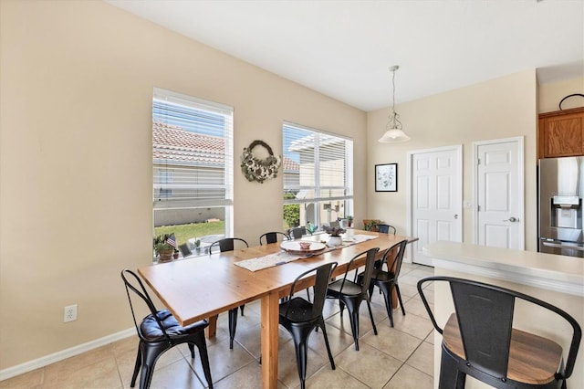 dining space with light tile patterned flooring and baseboards