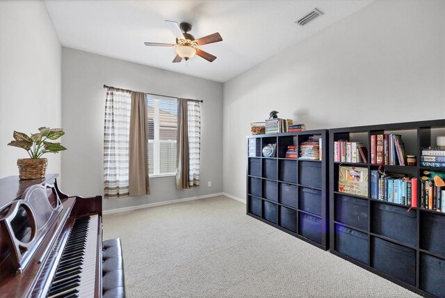 living area featuring a ceiling fan, visible vents, carpet floors, and baseboards