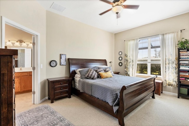 bedroom with baseboards, visible vents, and light carpet