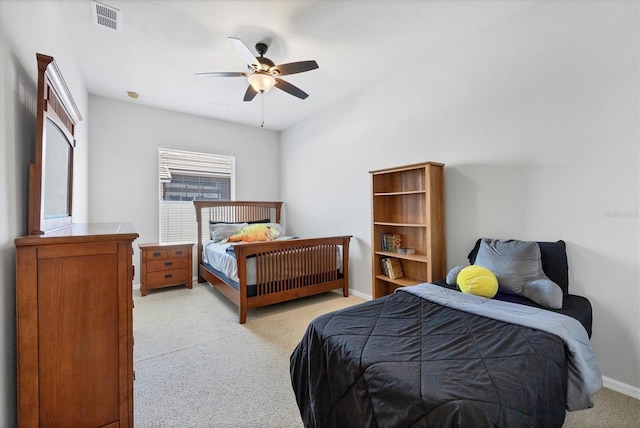 bedroom with visible vents, baseboards, light colored carpet, and a ceiling fan