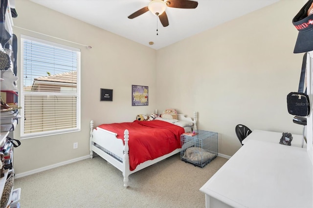 carpeted bedroom with baseboards and ceiling fan