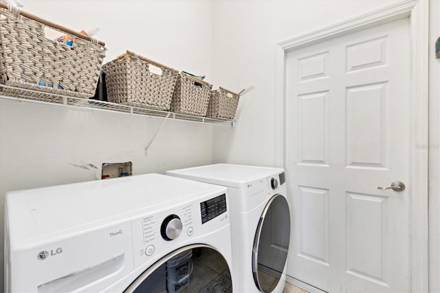 washroom with laundry area and washing machine and dryer