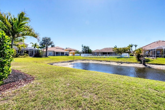 view of yard featuring fence and a water view