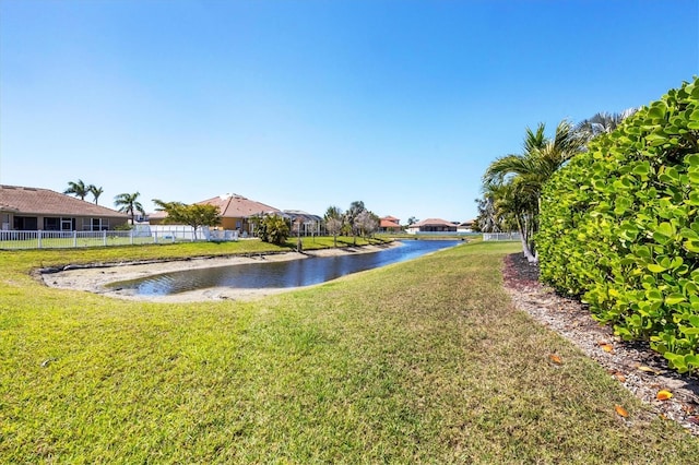 exterior space featuring a water view and fence