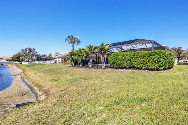 view of yard featuring a lanai and fence