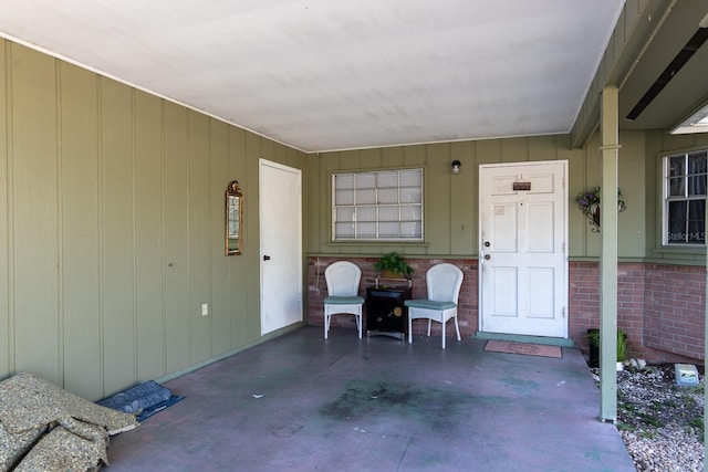 doorway to property featuring brick siding