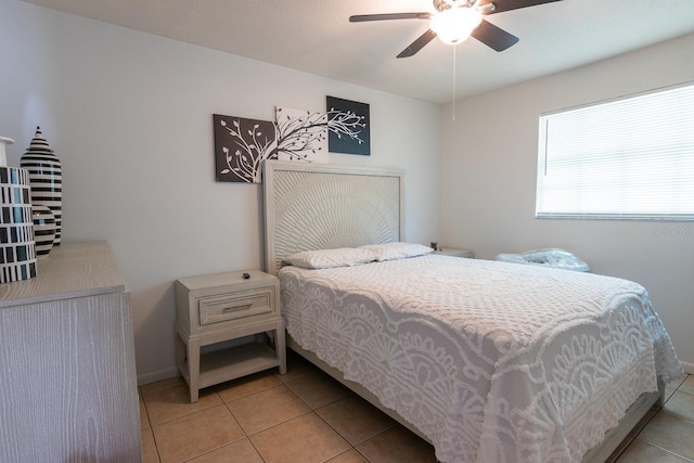 bedroom featuring light tile patterned floors, ceiling fan, and baseboards