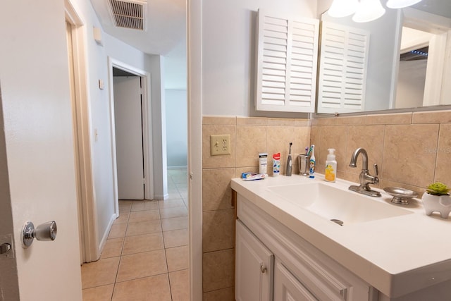 bathroom featuring visible vents, tile walls, vanity, and tile patterned flooring