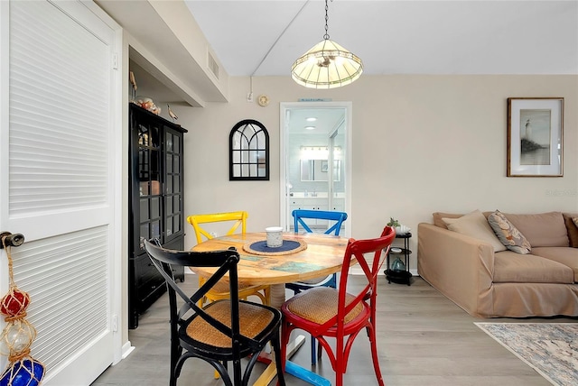 dining area with visible vents and light wood finished floors