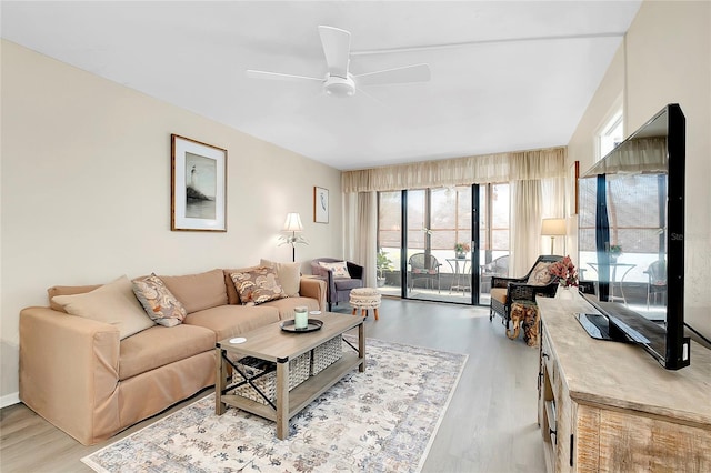 living area with wood finished floors and ceiling fan