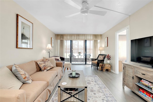 living room with wood finished floors and a ceiling fan