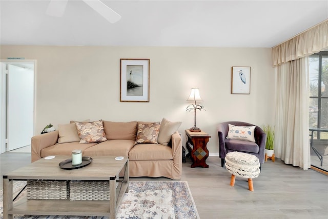 living room with light wood-style flooring and a ceiling fan