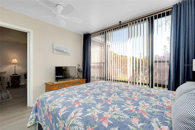 bedroom with a ceiling fan and wood finished floors