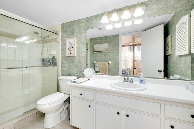 bathroom with toilet, wallpapered walls, a shower stall, tile patterned flooring, and vanity