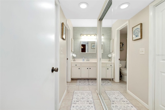 full bathroom featuring vanity, tile patterned floors, toilet, and baseboards