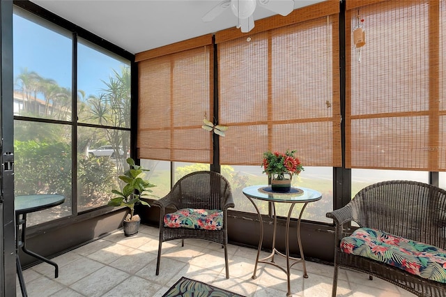 sunroom featuring a healthy amount of sunlight and a ceiling fan