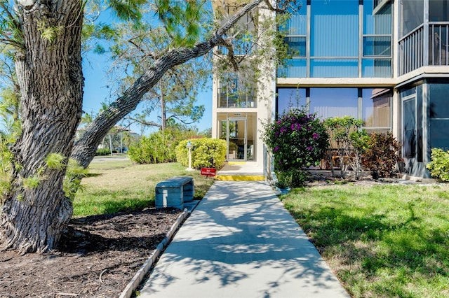 property entrance with a lawn