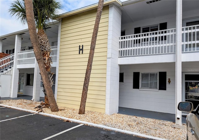 view of property exterior featuring uncovered parking