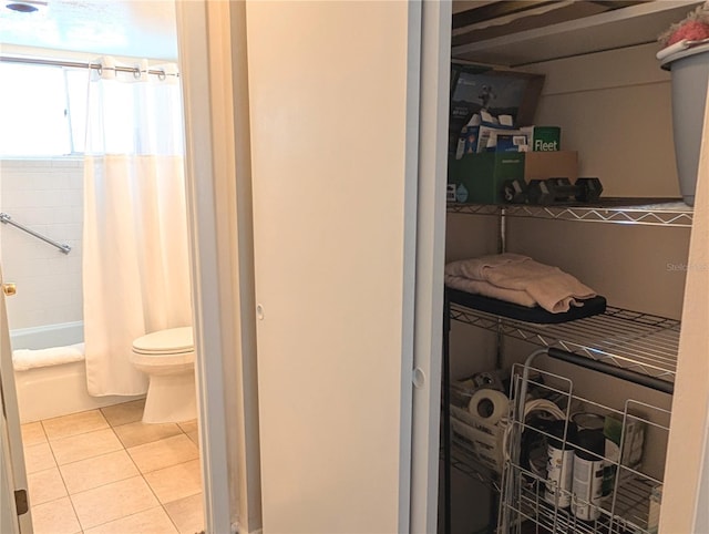 bathroom with tile patterned flooring, toilet, and shower / bath combo with shower curtain